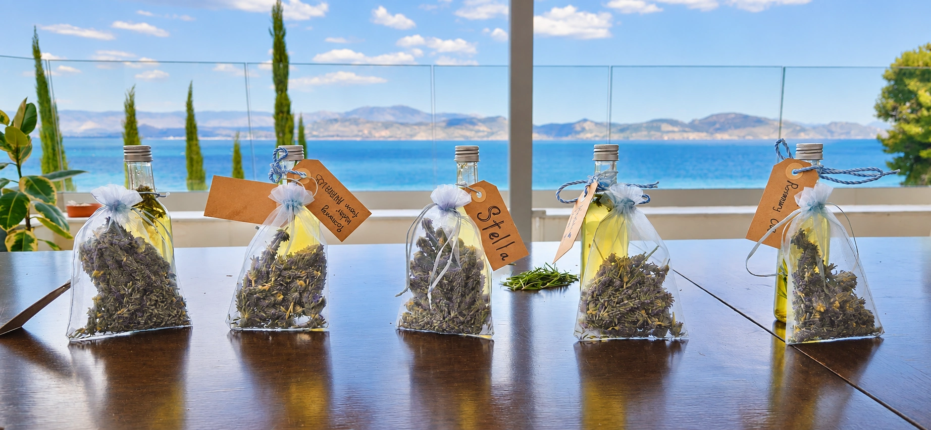 Handmade herbal keepsakes on a table overlooking the sea