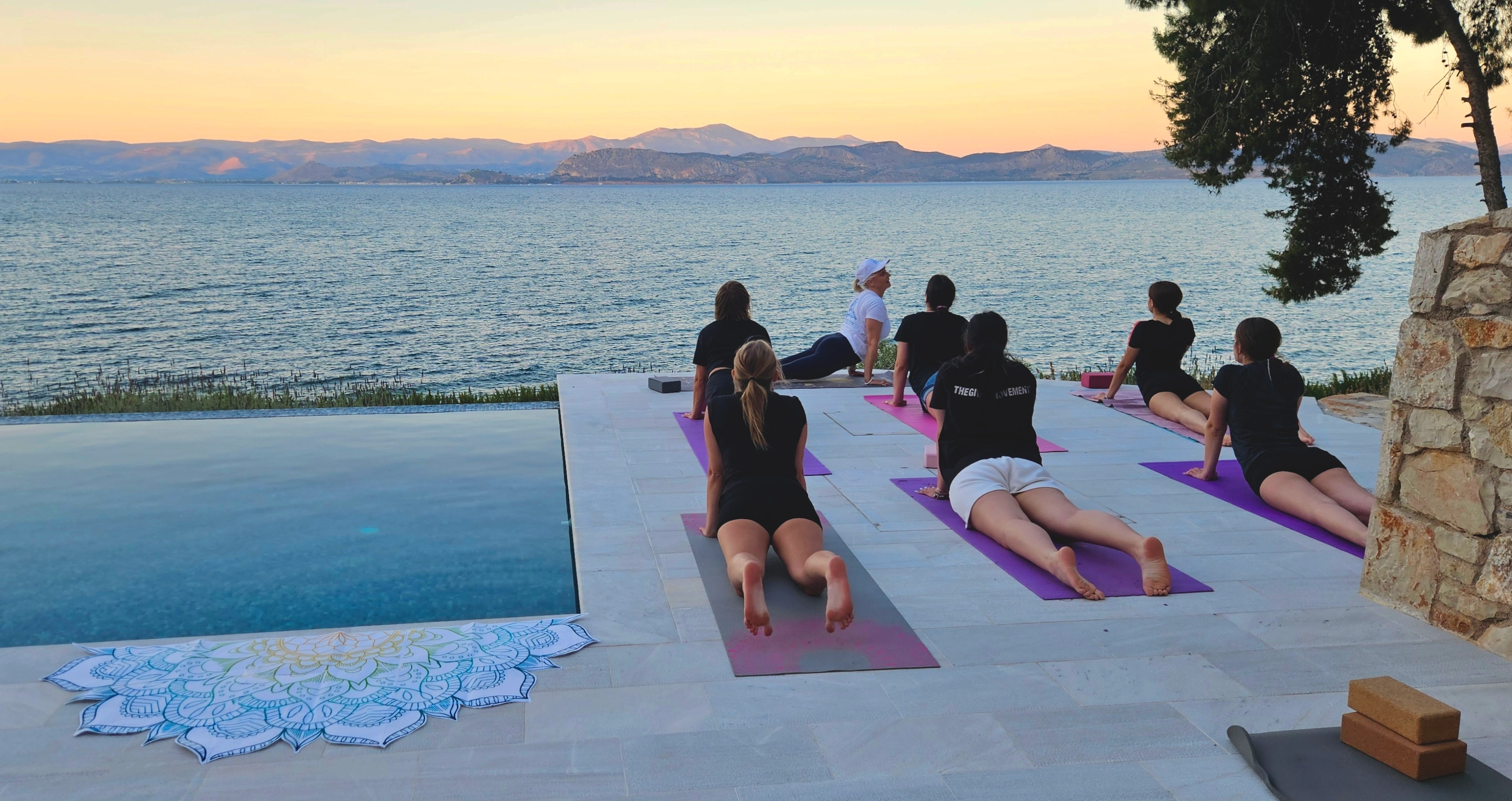 An evening yoga session facing the sea by the infinity pool